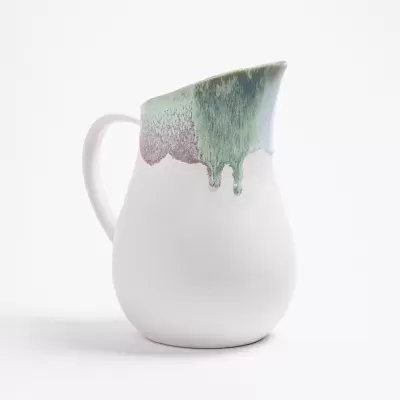 Jarro de cerâmica branca com acabado esmaltado colorido escorrendo