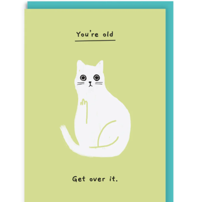 Cartão verde com gato branco e texto 'You're old' e 'Get over it.' com envelope azul.