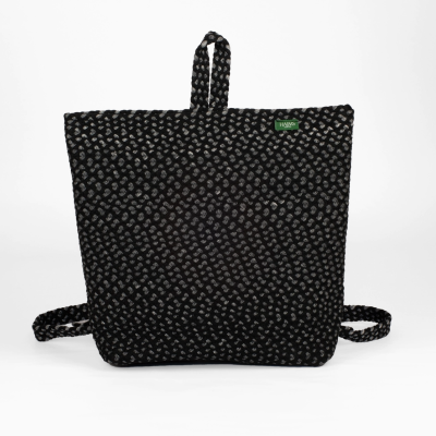 Mochila preta com padrão de pequenas flores brancas e etiqueta HAXXO