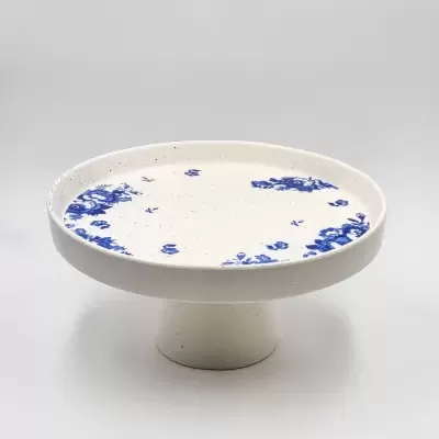 Prato de cerâmica branco com detalhes azuis e base larga
