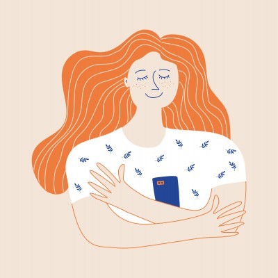 Mulher ruiva com t-shirt branca e telemóvel azul