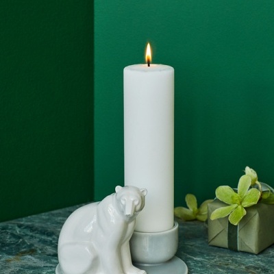 Castiçal branco em cerâmica com figura de urso e vela acesa