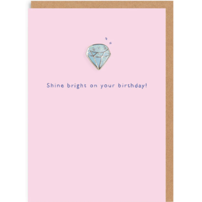 Cartão rosa claro com diamante azul e texto 'Shine bright on your birthday!'