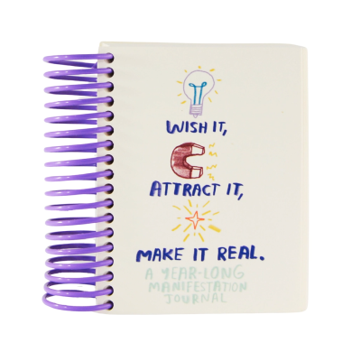 Caderno com capa branca e espiral roxa com texto WISH IT, ATTRACT IT, MAKE IT REAL.