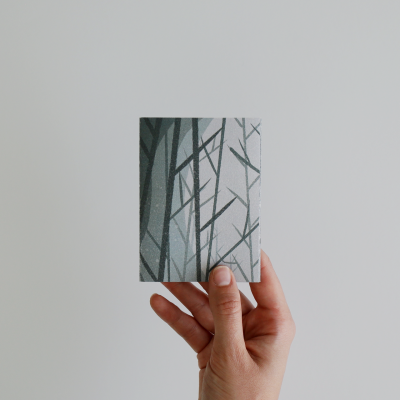 Cartão cinzento com padrão de ramos segurado por mão