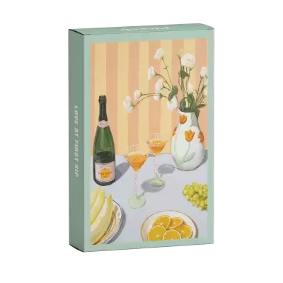 Caixa de produto com imagem de champanhe, taças, jarro com flores e frutas