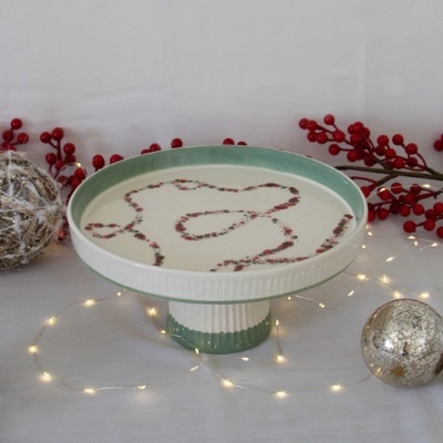 Boleira de cerâmica verde e branco com padrão de frutos vermelhos e decoração natalícia