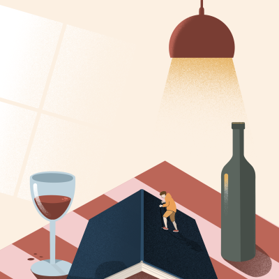 Mesa com livro aberto, copo de vinho, garrafa e lâmpada pendente iluminando