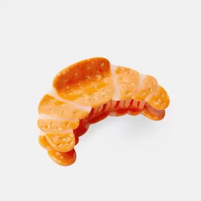 Grampo de cabelo em formato de croissant alaranjado