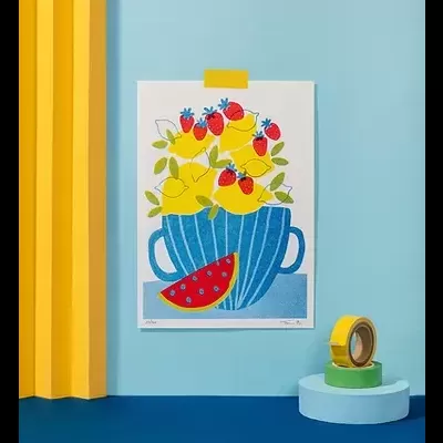 Cartaz colorido de caneca azul com frutas colado à parede azul clara