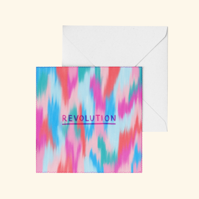 Cartão colorido com a palavra REVOLUTION e envelope branco.