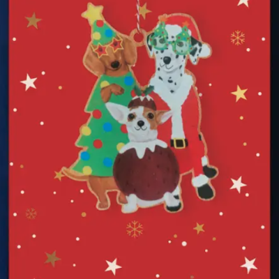 Etiqueta ou cartão vermelho com três cães vestidos para Natal e estrelas decorativas