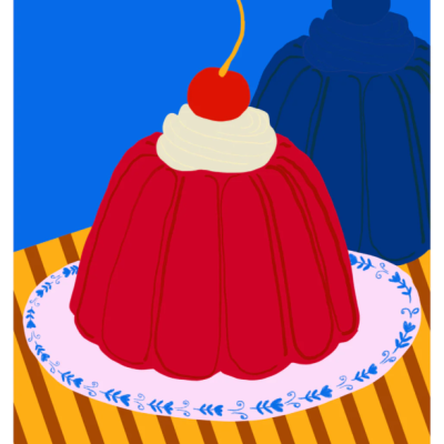 Dois pudins coloridos com creme e cerejas em prato decorado numa mesa riscada