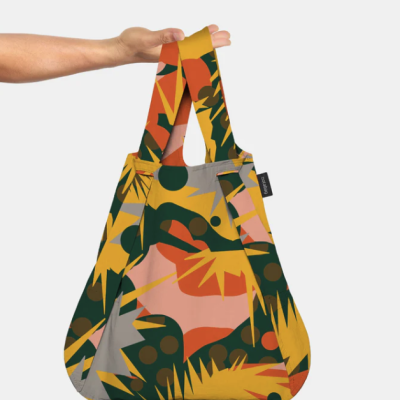 Mala de tecido com padrão geométrico colorido e etiqueta LOQI