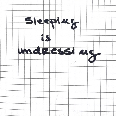 Página de caderno quadriculado com texto escrito à mão 'Sleeping is undressing'