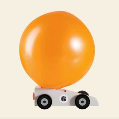 Carrinho de brinquedo branco com balão laranja