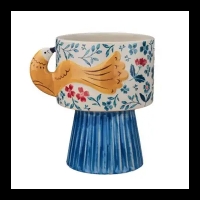 Caneca cerâmica com pega de pássaro amarelo e base azul texturizada