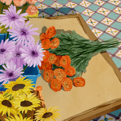 Mesa com toalha geométrica e três arranjos de flores coloridas