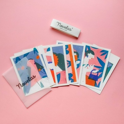 Conjunto de cartas ilustradas coloridas com embalagem 'Novelas' em fundo rosa