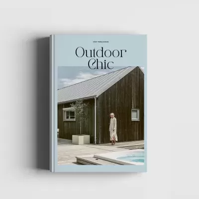 Livro Outdoor Chic com capa azul e imagem de casa de madeira e piscina
