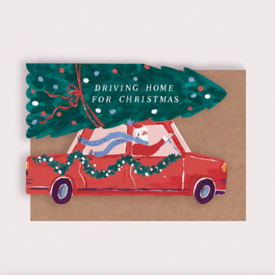 Cartão de Natal com carro vermelho e árvore de Natal verde com texto