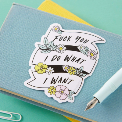 Adesivo decorativo com texto atrevido em caderno azul e caneta ao lado