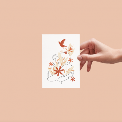 Cartão com ilustração de mãos e flores em tons quentes segurado por uma mão.