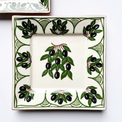 Prato quadrado de cerâmica branca com desenhos de azeitonas verdes e pretas