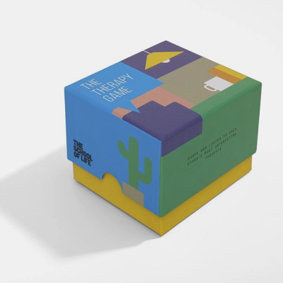 Caixa colorida do jogo THE THERAPY GAME com ilustrações de cacto e formas geométricas