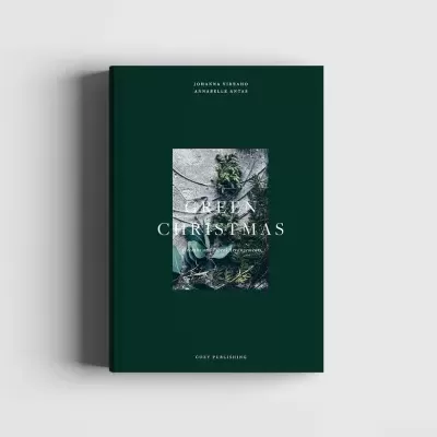 Livro capa dura verde escura com imagem de folhas e texto branco