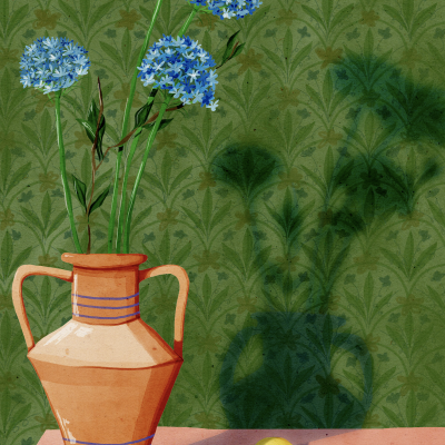 Vaso de cerâmica com flores azuis, limões e copo sobre mesa rosa, fundo verde com padrões