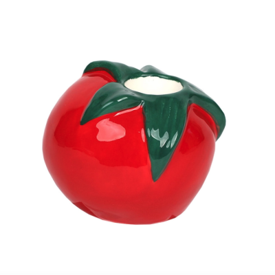 Castiçal em forma de tomate vermelho com folhas verdes