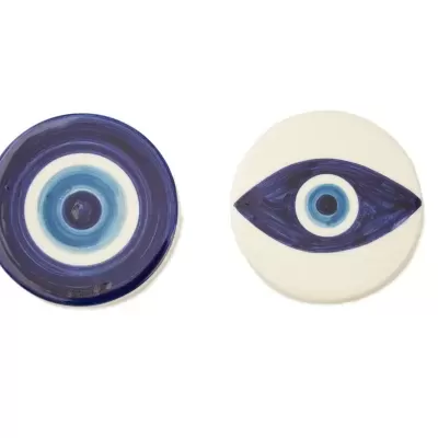 Dois porta-copos cerâmicos com desenhos de olhos em tons de azul e branco