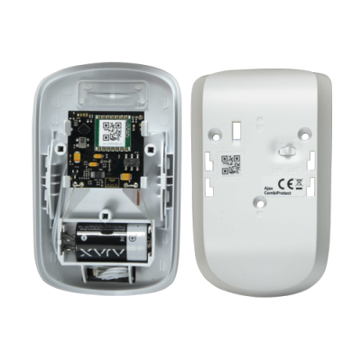 Dispositivo eletrónico branco aberto mostrando circuitos e bateria, com verso com interruptor on/off e marcações.