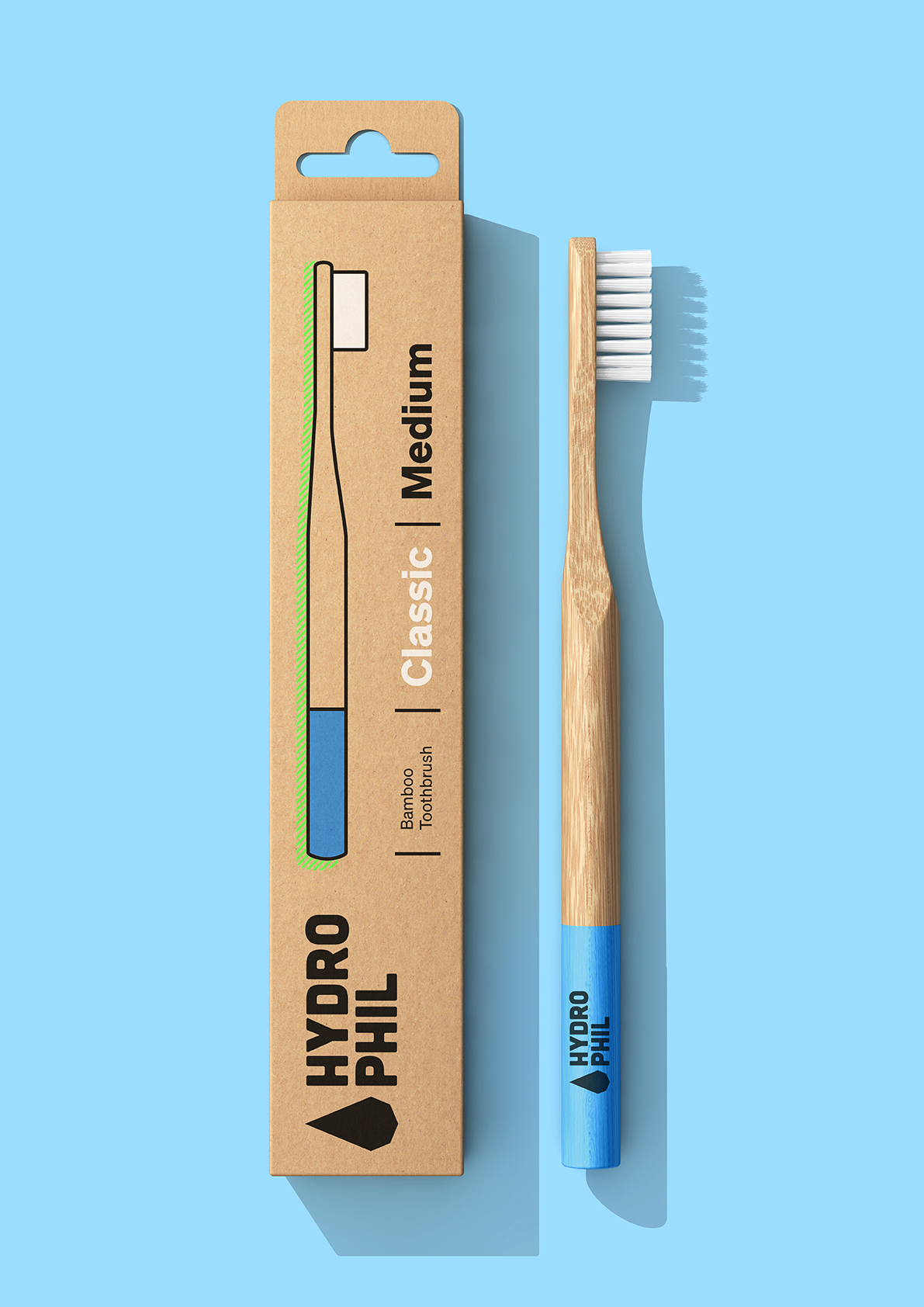 Escova de Dentes de Bambu Hydrophil - Média Escova de dentes HYDRO PHIL Classic Medium de bambu com cerdas brancas e pega azul ao lado da embalagem