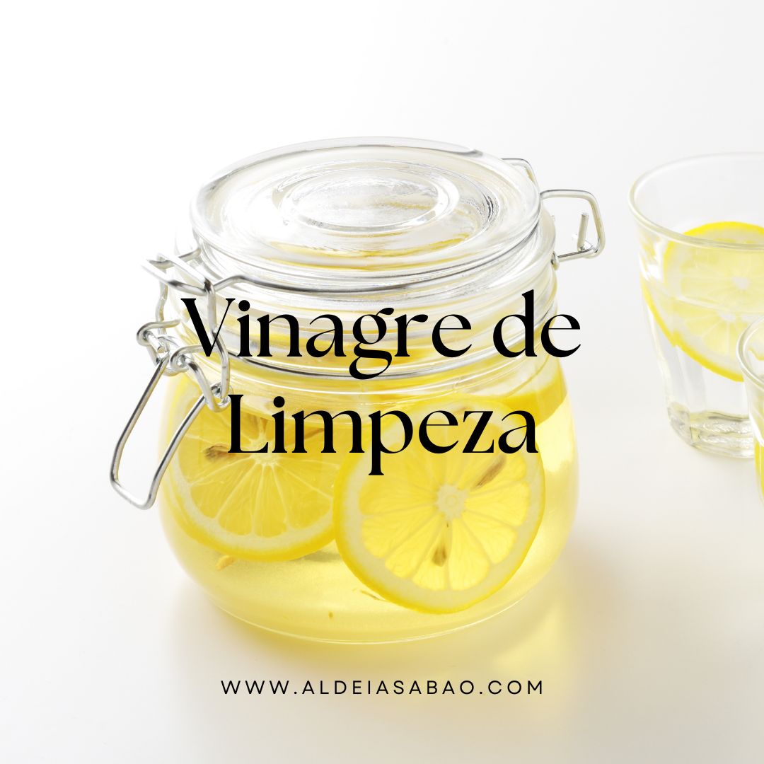 Frasco de vidro com líquido amarelo e rodelas de limão e copo ao lado