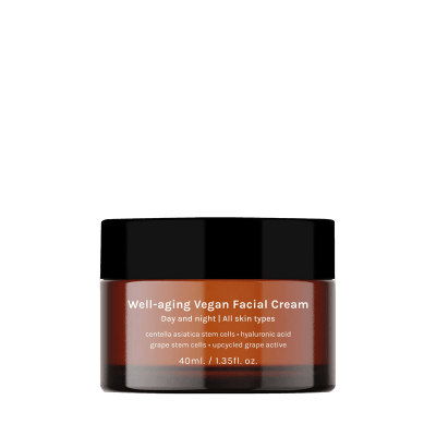 Frasco de creme facial vegano castanho com tampa preta e texto branco.