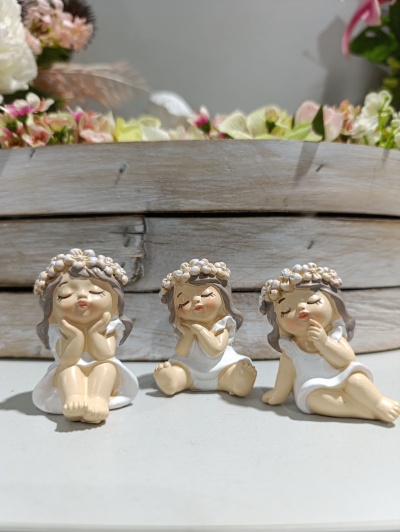 Três estatuetas decorativas de raparigas com coroas de flores e vestidos brancos
