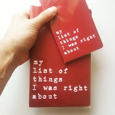 Cadernos vermelhos com texto branco 'my list of things I was right about' em fundo branco.