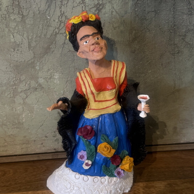 Figurinha colorida de mulher com vestido e flores sobre base branca texturizada
