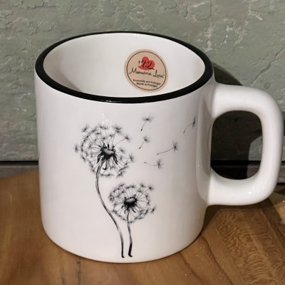 Caneca branca com desenho de dentes-de-leão e selo Memória Lenta
