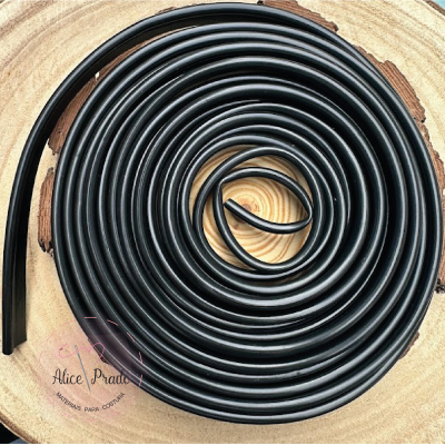 Fita de borracha preta enrolada sobre madeira redonda