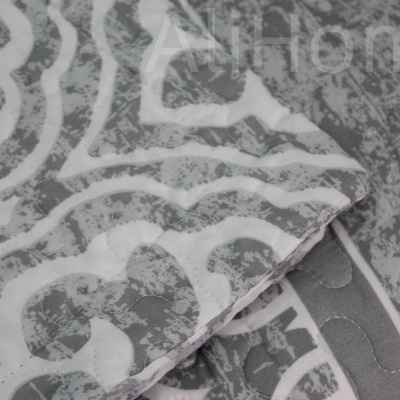 Têxteis cinzentos com padrão branco e textura acolchoada