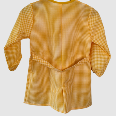 Casaco infantil amarelo xadrez com mangas compridas e cinto num cabide