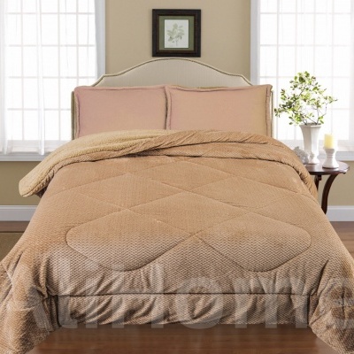 Cama de casal com roupa de cama castanha e almofadas cor-de-rosa, mesa lateral com vaso branco, flores e janelas ao fundo