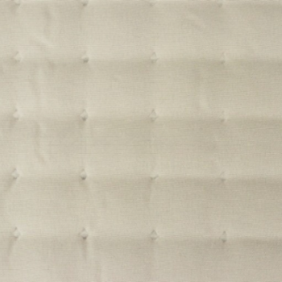 superfície estofada em tecido creme acolchoado com padrão quadrado