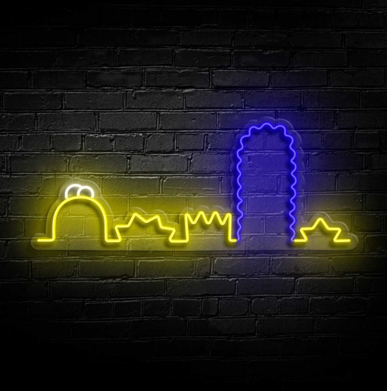 NeonLED | Simpsons Luz de neon amarela e azul com desenhos arquitetónicos sobre parede de tijolo preto