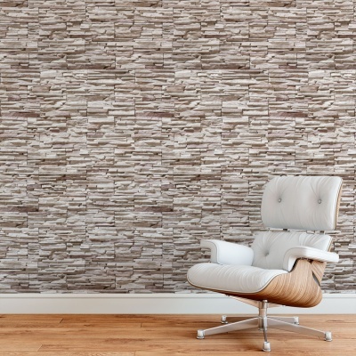 Cadeira branca de design moderno junto a parede com papel de parede padrão pedra