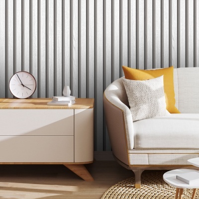 Sala moderna com sofá branco e almofadas amarelas, móvel e relógio branco sobre mesa de madeira, parede cinza texturizada.