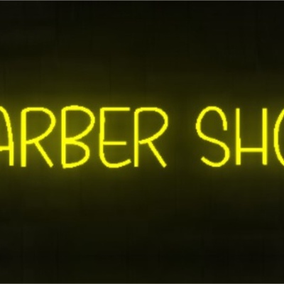 Letreiro luminoso em néon amarelo com texto 'BARBER SHOP'